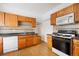 Kitchen with wood cabinets, gas range, and dishwasher at 403 W 3Rd Ave, Denver, CO 80223