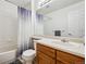 Clean bathroom with a shower-tub combo, decorative shower curtain, vanity, and bright countertop at 12850 Ventana St, Parker, CO 80134