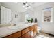 Bathroom featuring double sinks, a large mirror, and natural light from a window in a home at 12850 Ventana St, Parker, CO 80134
