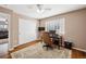 Bedroom with built-in desk, ceiling fan, and light walls, and carpet to soften the space at 12850 Ventana St, Parker, CO 80134