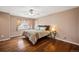 Cozy bedroom with hardwood floors, ceiling fan, and a comfortable bed at 12850 Ventana St, Parker, CO 80134