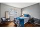 Bedroom featuring hardwood floors, a full-length mirror, and stylish furniture at 12850 Ventana St, Parker, CO 80134
