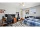 Neat bedroom with desk, hardwood floors, and natural light at 12850 Ventana St, Parker, CO 80134