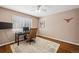 Bedroom features hard wood flooring, natural light, ceiling fan and built in desk with leather office chair at 12850 Ventana St, Parker, CO 80134