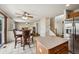 Open-concept home featuring a breakfast bar, a living area with hardwood floors, and a kitchen with stainless appliances at 12850 Ventana St, Parker, CO 80134