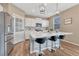 Modern kitchen with island, stainless steel appliances, and white cabinetry at 14021 Scarlet Sage St, Parker, CO 80134