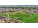 A scenic aerial view shows the beautiful neighborhood and green community park at 14278 Greenfield Loop, Parker, CO 80134