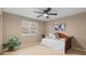 Bright bedroom featuring a daybed, neutral walls, and a ceiling fan for a comfortable and inviting space at 14278 Greenfield Loop, Parker, CO 80134