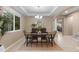 Inviting dining room with a stylish chandelier, large windows, and a table set for a meal at 14278 Greenfield Loop, Parker, CO 80134