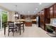 Well-lit kitchen with stainless steel appliances, a center island, and an adjacent dining area at 14278 Greenfield Loop, Parker, CO 80134
