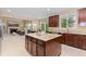 Spacious kitchen with a center island, granite countertops, and views of the living room and dining area at 14278 Greenfield Loop, Parker, CO 80134