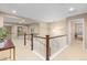 Open landing with wood railings, neutral walls, and natural light creating a welcoming atmosphere at 14278 Greenfield Loop, Parker, CO 80134
