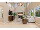 Bright living room with a fireplace, comfortable seating, and views to a second-floor landing at 14278 Greenfield Loop, Parker, CO 80134