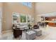 Open-concept living room with high ceilings, ample natural light, and a view of the dining area at 14278 Greenfield Loop, Parker, CO 80134