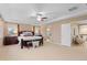Spacious main bedroom featuring a tray ceiling, ceiling fan, and an en-suite bathroom at 14278 Greenfield Loop, Parker, CO 80134