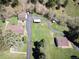 Aerial view of a property with multiple buildings on a large lawn, connected by a long driveway in a rural area at 10049 S Turkey Creek Rd, Morrison, CO 80465