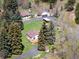 Aerial view of a charming home with a well-maintained lawn and mature trees surrounding the property at 10049 S Turkey Creek Rd, Morrison, CO 80465