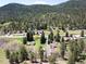 Expansive aerial view of a tranquil community surrounded by lush forests and rolling hills at 10049 S Turkey Creek Rd, Morrison, CO 80465