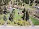 Overhead view of a home nestled among mature trees and a well-manicured lawn, blending nature and comfort at 10049 S Turkey Creek Rd, Morrison, CO 80465