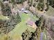 High angle view of a home surrounded by lush greenery, showcasing a spacious yard and natural setting at 10049 S Turkey Creek Rd, Morrison, CO 80465