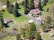 Bird's eye view showcasing the layout of the house, outbuildings, and surrounding landscape at 10049 S Turkey Creek Rd, Morrison, CO 80465