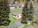 Aerial view of a house featuring a well-maintained lawn and mature trees, enhancing its outdoor appeal at 10049 S Turkey Creek Rd, Morrison, CO 80465