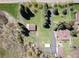 Aerial shot showcasing the property's layout with driveway, mature trees, and adjacent creek at 10049 S Turkey Creek Rd, Morrison, CO 80465