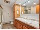 Functional bathroom with a double sink vanity and wood cabinets at 10049 S Turkey Creek Rd, Morrison, CO 80465
