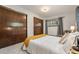 Comfortable bedroom with plush carpet, a queen bed with decorative pillows, and natural lighting at 10049 S Turkey Creek Rd, Morrison, CO 80465