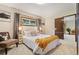 Bright bedroom with plush carpet, a queen bed with decorative pillows, and natural lighting at 10049 S Turkey Creek Rd, Morrison, CO 80465