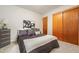Comfortable bedroom features plush carpet, a queen bed with decorative pillows, and a closet at 10049 S Turkey Creek Rd, Morrison, CO 80465