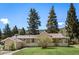 Charming single-story home with a covered front porch, mature trees, and well-maintained landscaping at 10049 S Turkey Creek Rd, Morrison, CO 80465