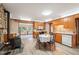 Country kitchen featuring wood cabinets, white appliances, wood-burning stove and attached breakfast nook with a view at 10049 S Turkey Creek Rd, Morrison, CO 80465