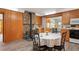 Functional kitchen with wood cabinets, white appliances, wood-burning stove and breakfast nook with table and chairs at 10049 S Turkey Creek Rd, Morrison, CO 80465