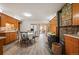 Charming country kitchen featuring wood cabinets, brick accents, wood-burning stove and breakfast nook at 10049 S Turkey Creek Rd, Morrison, CO 80465