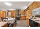 Charming kitchen with wood cabinets, updated appliances, and a stone fireplace at 10049 S Turkey Creek Rd, Morrison, CO 80465