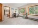 Bright living room with large windows, carpeted floors, and view into bedroom at 10049 S Turkey Creek Rd, Morrison, CO 80465
