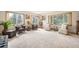 Bright living room featuring large windows with scenic views, plush carpeting, and cozy seating arrangements at 10049 S Turkey Creek Rd, Morrison, CO 80465