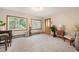 Bright living room with large windows, carpeted floors, and a decorative front door at 10049 S Turkey Creek Rd, Morrison, CO 80465