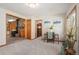 Spacious Living Room with view into Kitchen, wood trim, and new carpet at 10049 S Turkey Creek Rd, Morrison, CO 80465