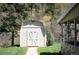 Charming outbuilding with double doors and a pathway, nestled among mature trees at 10049 S Turkey Creek Rd, Morrison, CO 80465