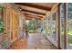 Cozy sunroom with wood beam ceiling, and furniture to relax and enjoy the nature outside at 10049 S Turkey Creek Rd, Morrison, CO 80465