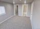 Spacious carpeted bedroom with ensuite bath and large window for natural light at 4720 Thompson Ct, Denver, CO 80216