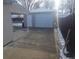 Detached garage featuring a new white door, side entry, and concrete driveway at 4720 Thompson Ct, Denver, CO 80216