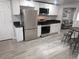 Open kitchen featuring stainless steel appliances, ample cabinet space, and a dining area at 4720 Thompson Ct, Denver, CO 80216