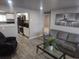Open-concept living room and kitchen featuring modern finishes and stylish decor at 4720 Thompson Ct, Denver, CO 80216