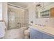 Bathroom featuring shower over tub with glass door and blue and white tiling at 55 Dexter St, Denver, CO 80220