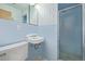 Bathroom featuring blue tiling, shower, and sink at 55 Dexter St, Denver, CO 80220