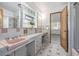 Bathroom with dual sinks and large mirror and pink and white tile at 55 Dexter St, Denver, CO 80220