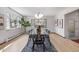 Dining room featuring hardwood floors, large windows, and modern lighting fixture at 55 Dexter St, Denver, CO 80220